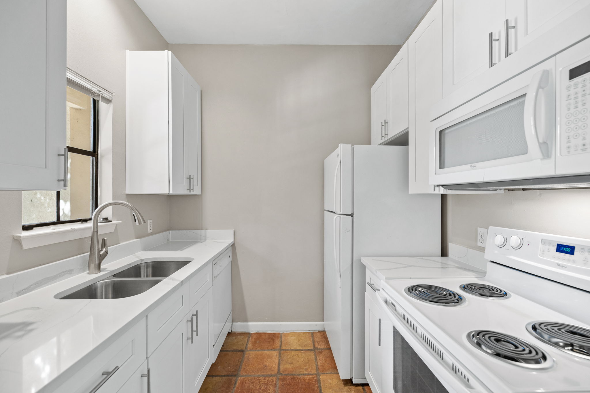 712 Graham Place, Unit 203 Austin, TX 78705 - Photo 7 of 30 a kitchen with stainless steel appliances granite countertop a sink stove and refrigerator