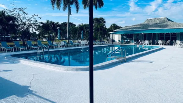 a swimming pool with outdoor seating and yard