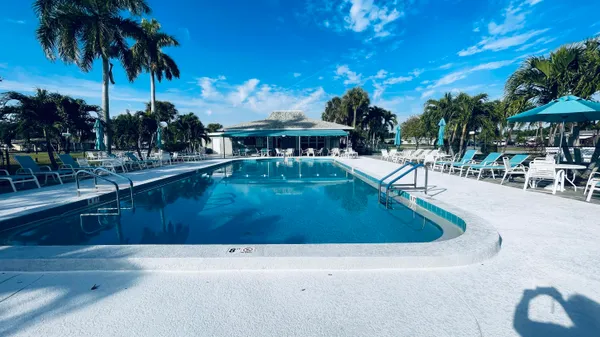 a view of a swimming pool with a table and chairs