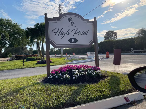 a view of a sign board with a yard