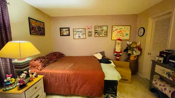 a bedroom with a bed and a dresser
