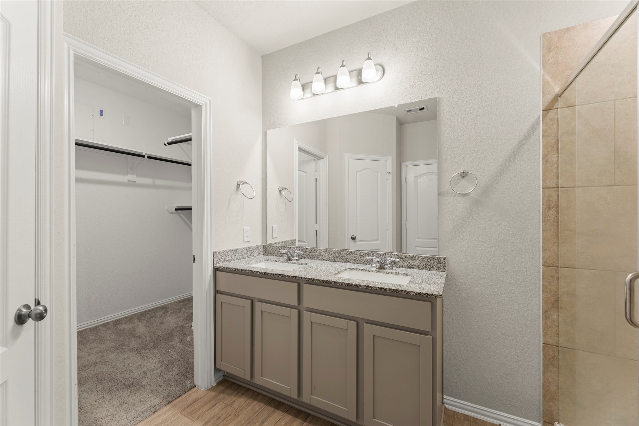 31322 Conover Drive Fulshear, TX 77441 - Photo 14 of 38 a bathroom with a granite countertop sink a mirror and a shower