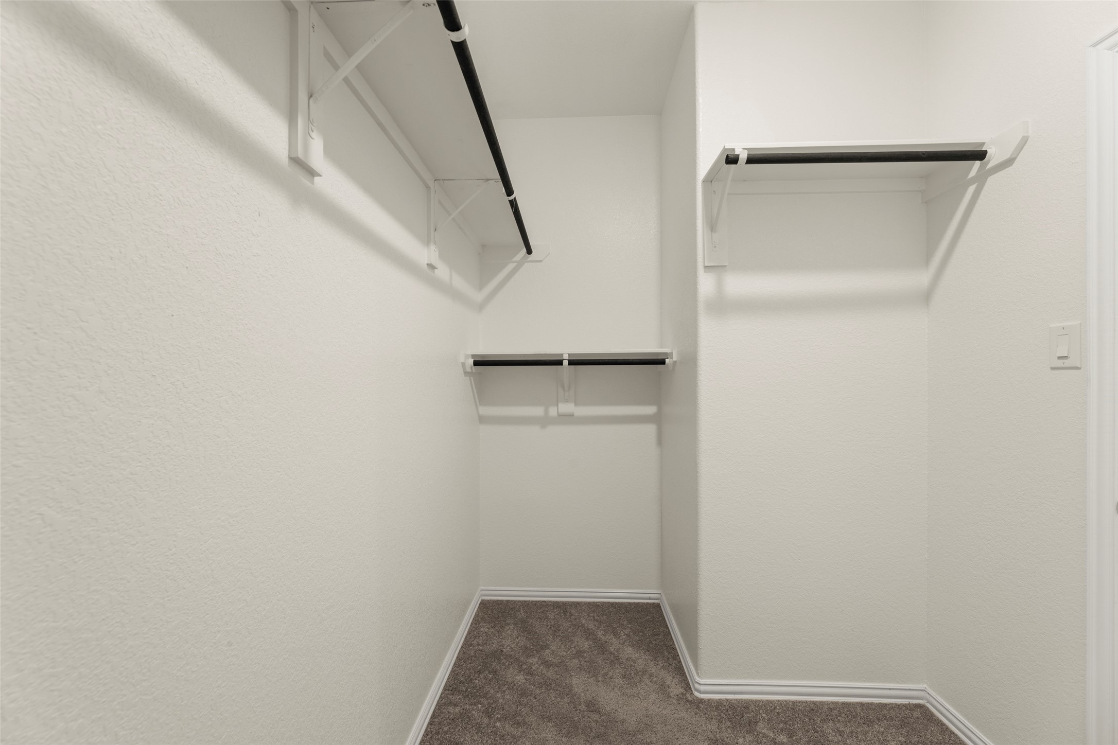 31322 Conover Drive Fulshear, TX 77441 - Photo 17 of 38 a view of walk in closet with empty racks