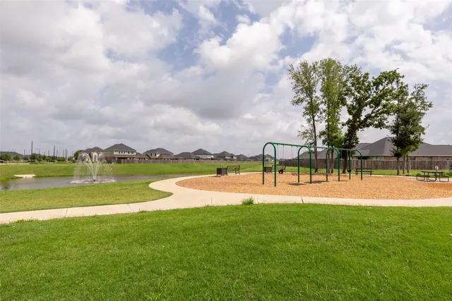 a view of a lake with houses in the back