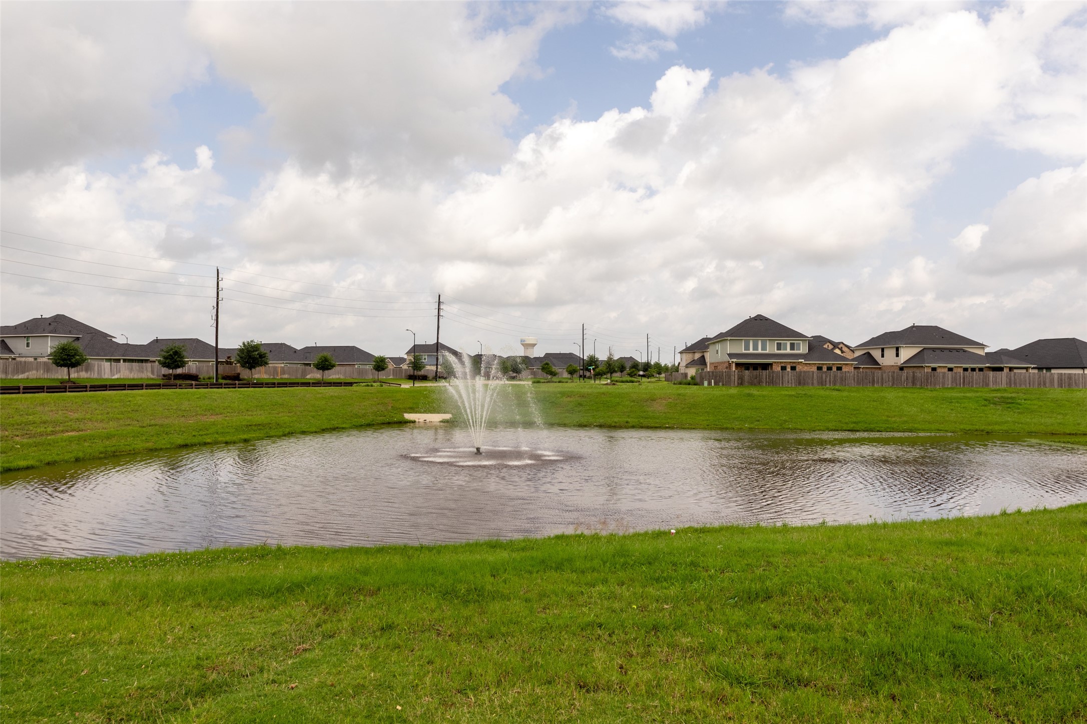 31322 Conover Drive Fulshear, TX 77441 - Photo 34 of 38 a view of a lake with houses in the back