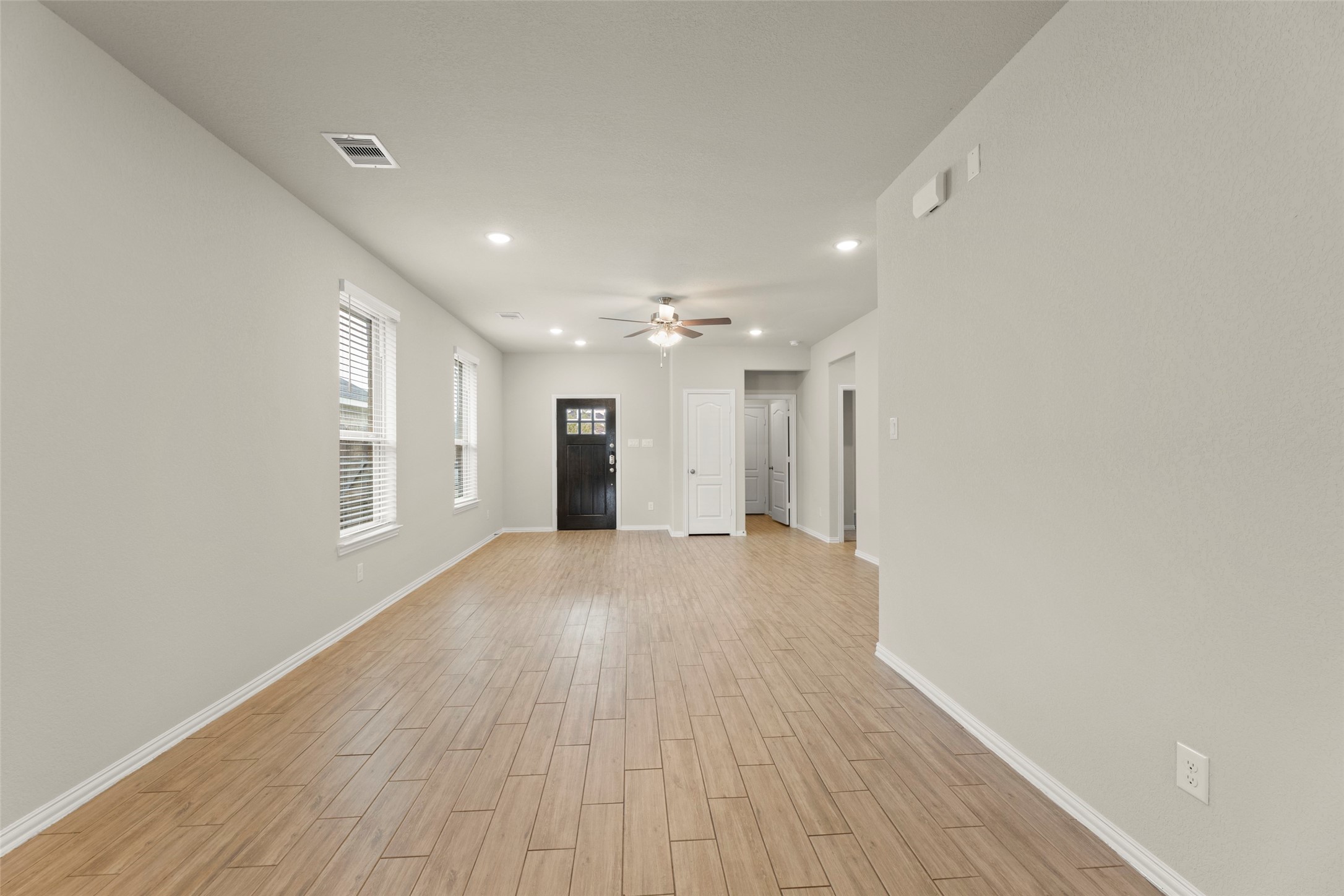 31322 Conover Drive Fulshear, TX 77441 - Photo 9 of 38 a view of an empty room with wooden floor and a window