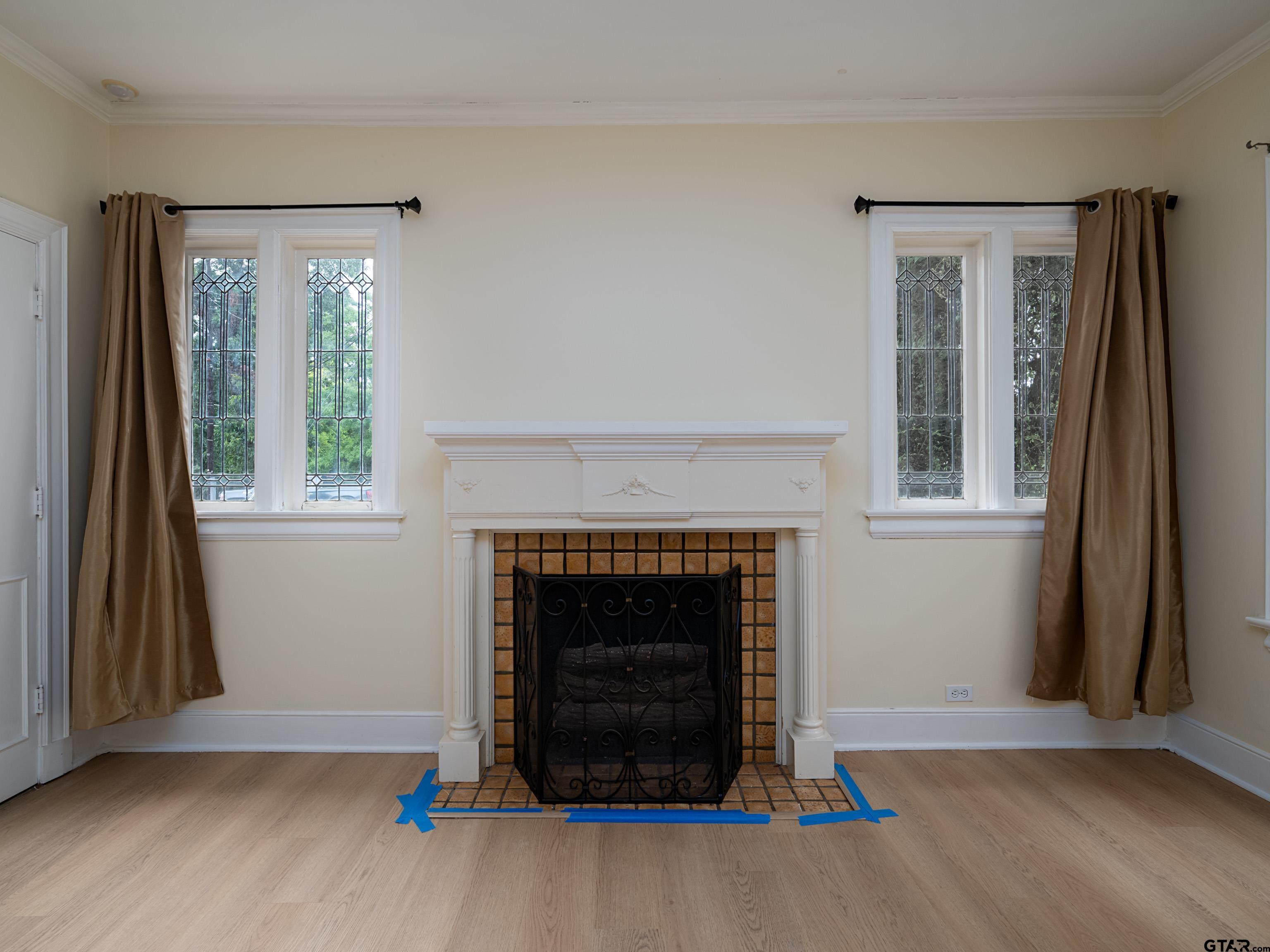 201 West Rusk Street Tyler, TX 75701 - Photo 11 of 30 a living room with a fireplace and a window