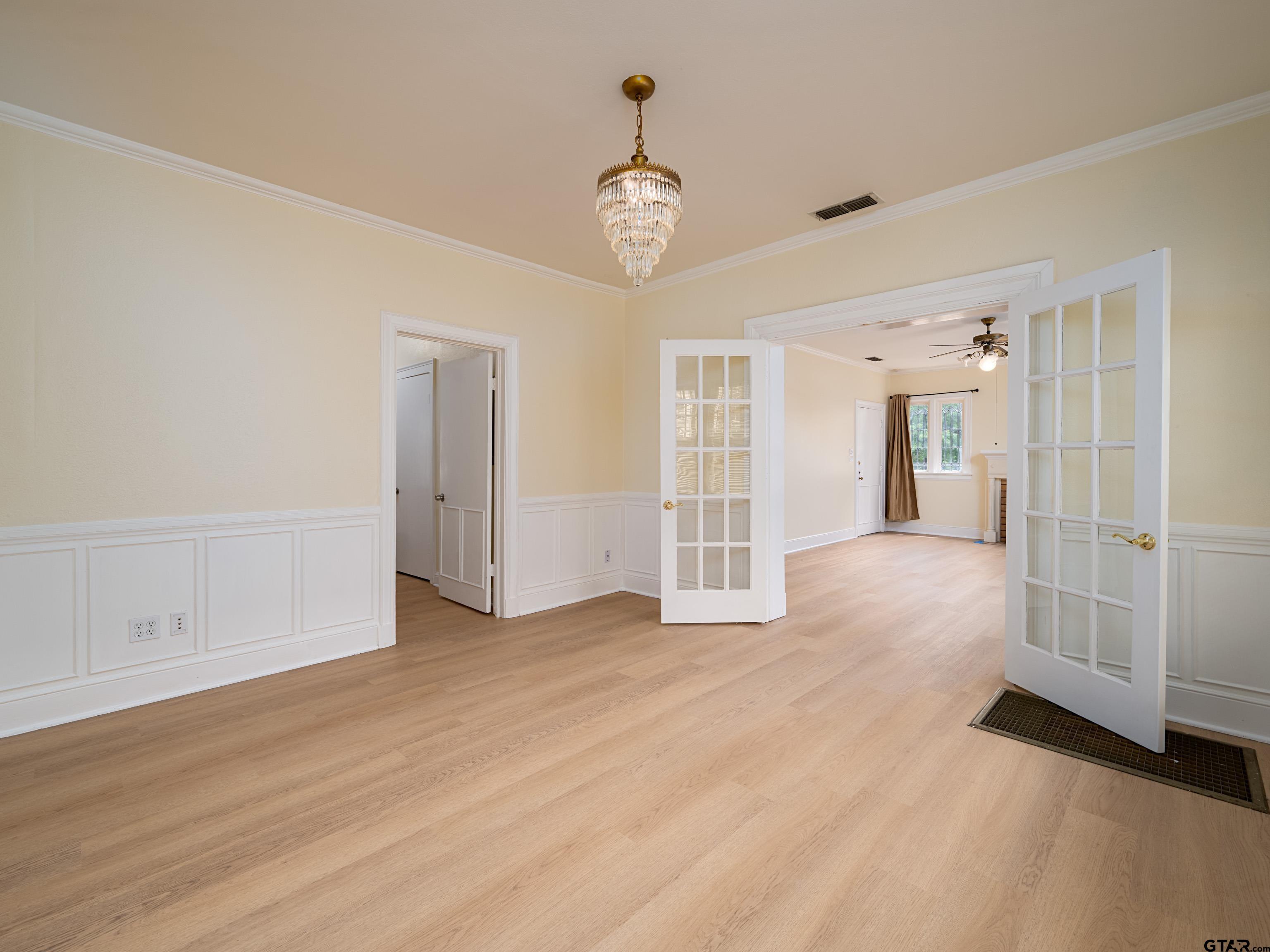 201 West Rusk Street Tyler, TX 75701 - Photo 13 of 30 a view of an empty room with wooden floor and a window