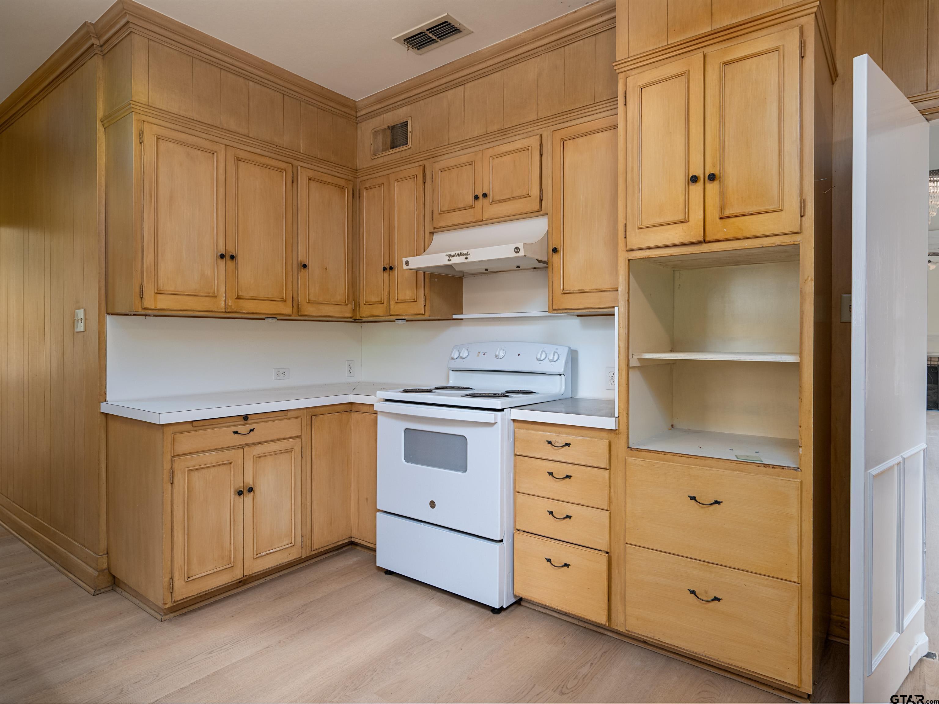 201 West Rusk Street Tyler, TX 75701 - Photo 15 of 30 a kitchen with white cabinets and a stove top oven