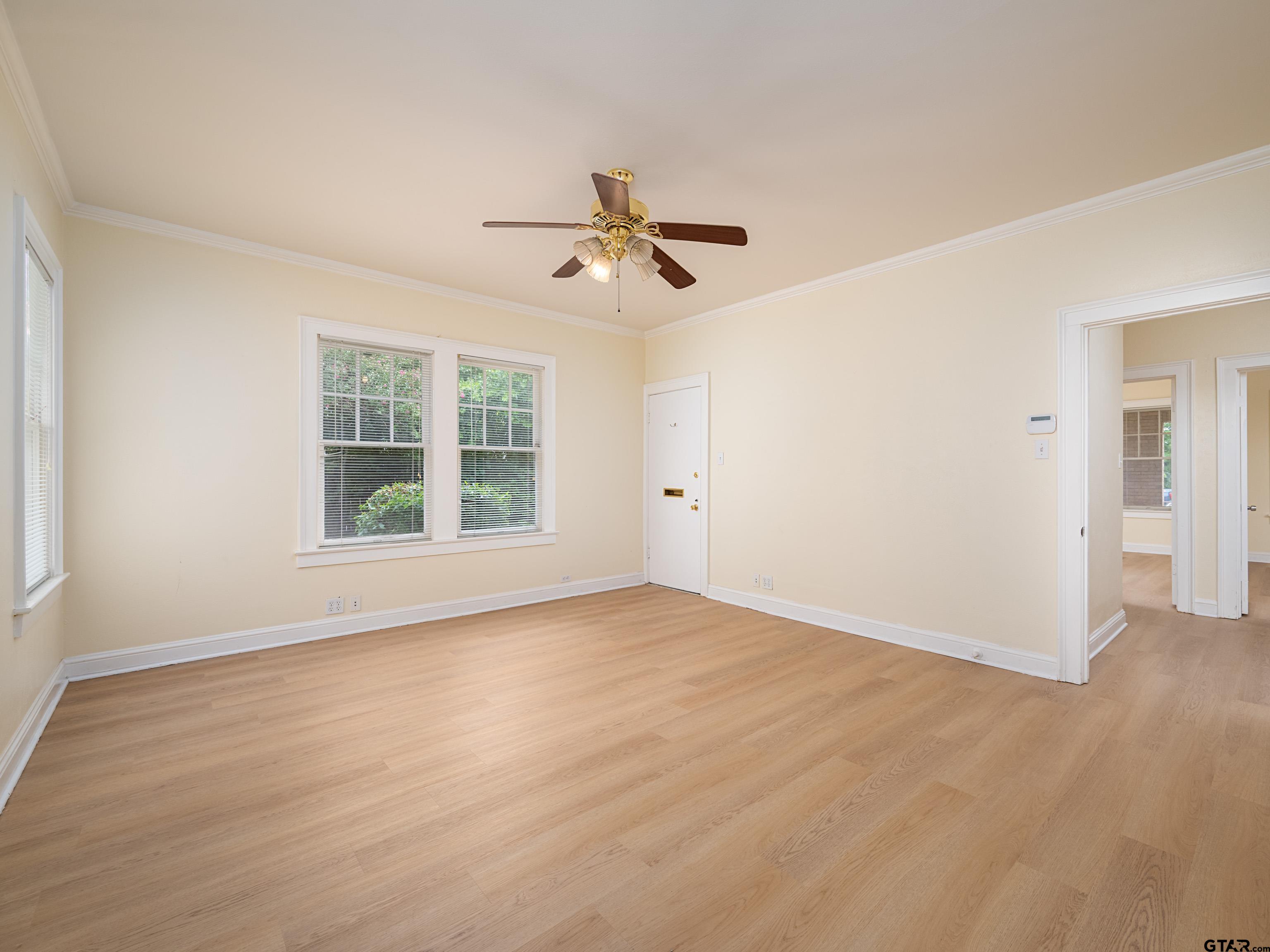 201 West Rusk Street Tyler, TX 75701 - Photo 19 of 30 wooden floor in an empty room with a window