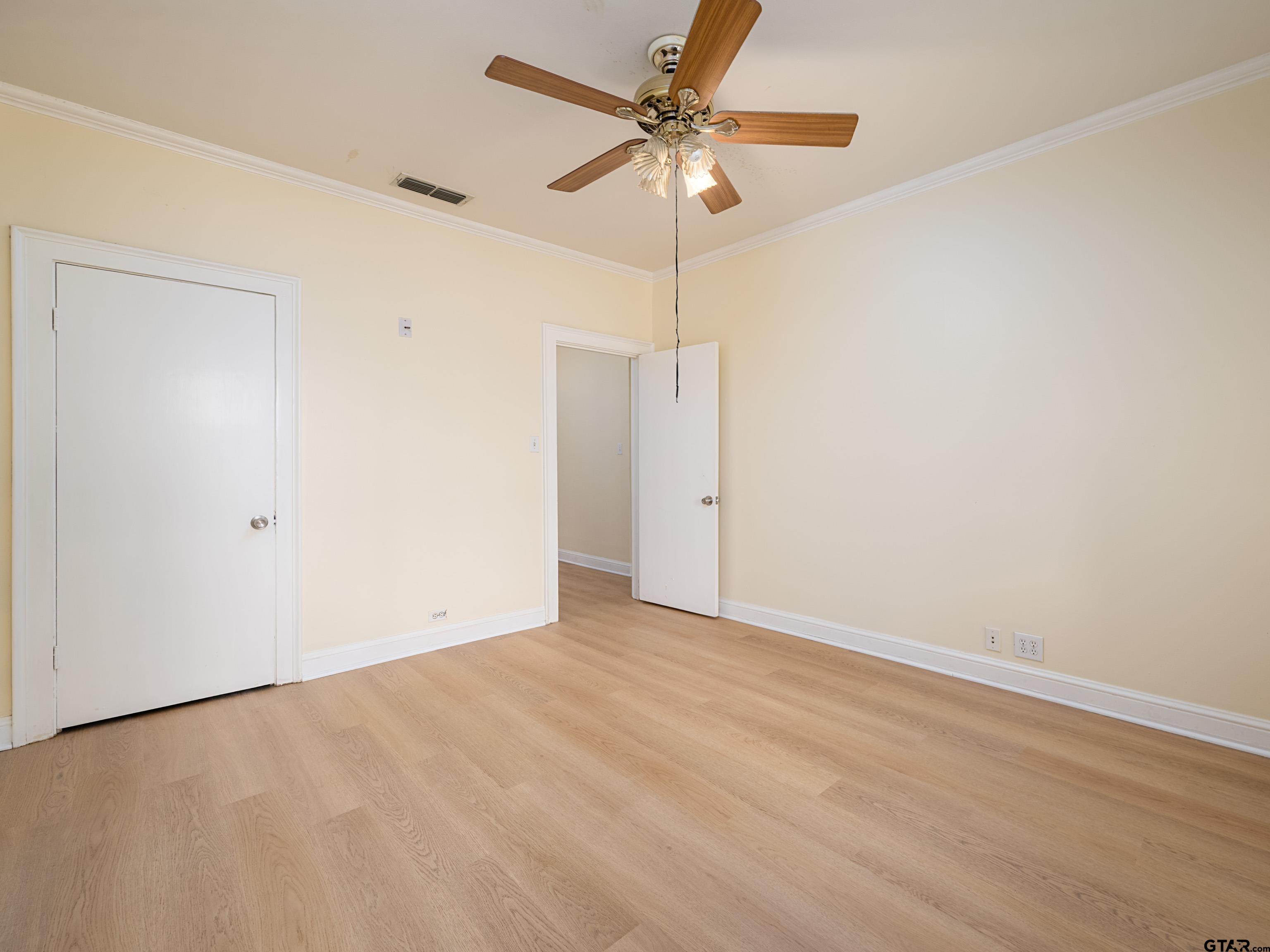 201 West Rusk Street Tyler, TX 75701 - Photo 27 of 30 an empty room with a ceiling fan and a window