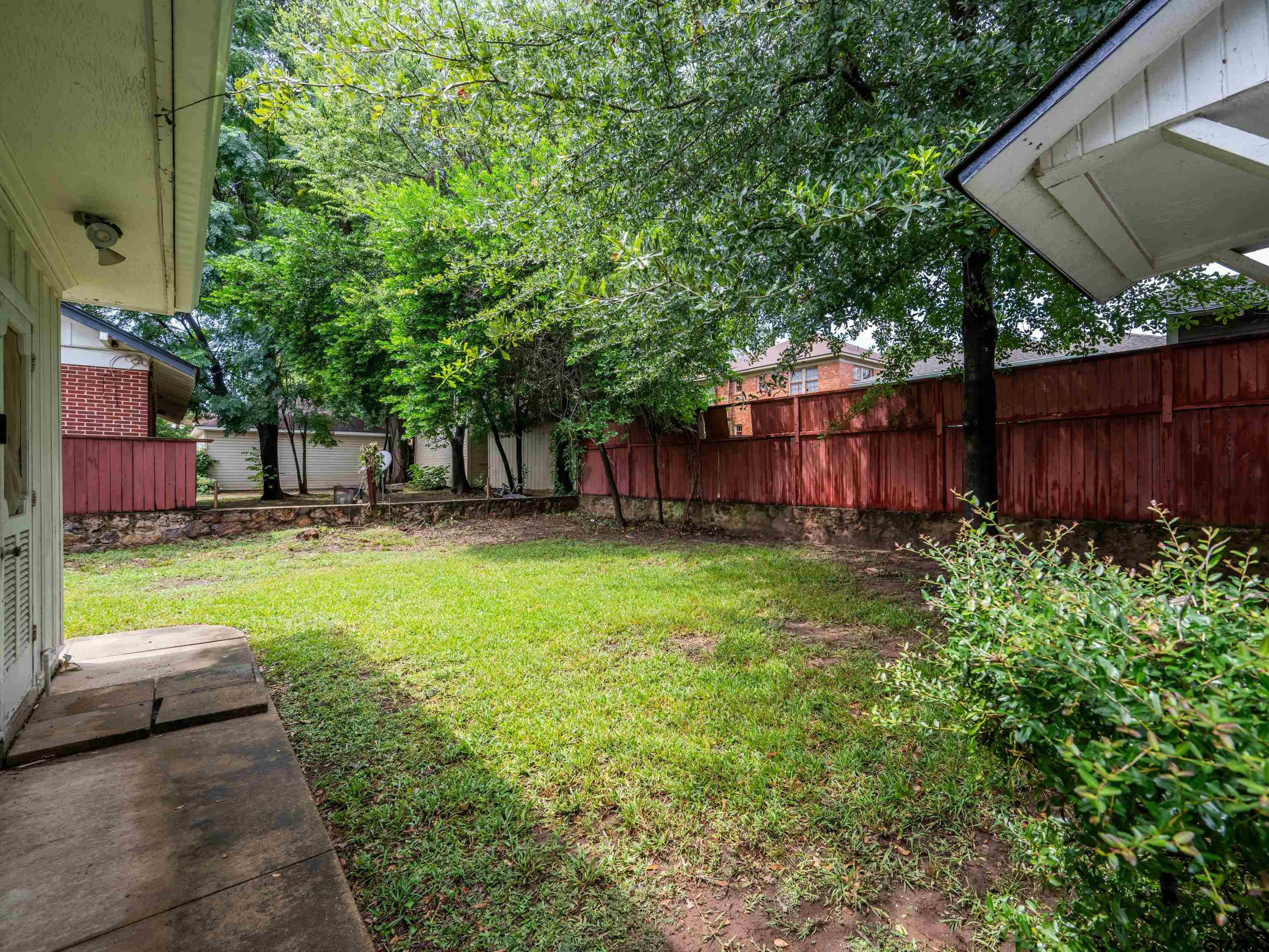 201 West Rusk Street Tyler, TX 75701 - Photo 29 of 30 a view of a backyard with a garden and trees
