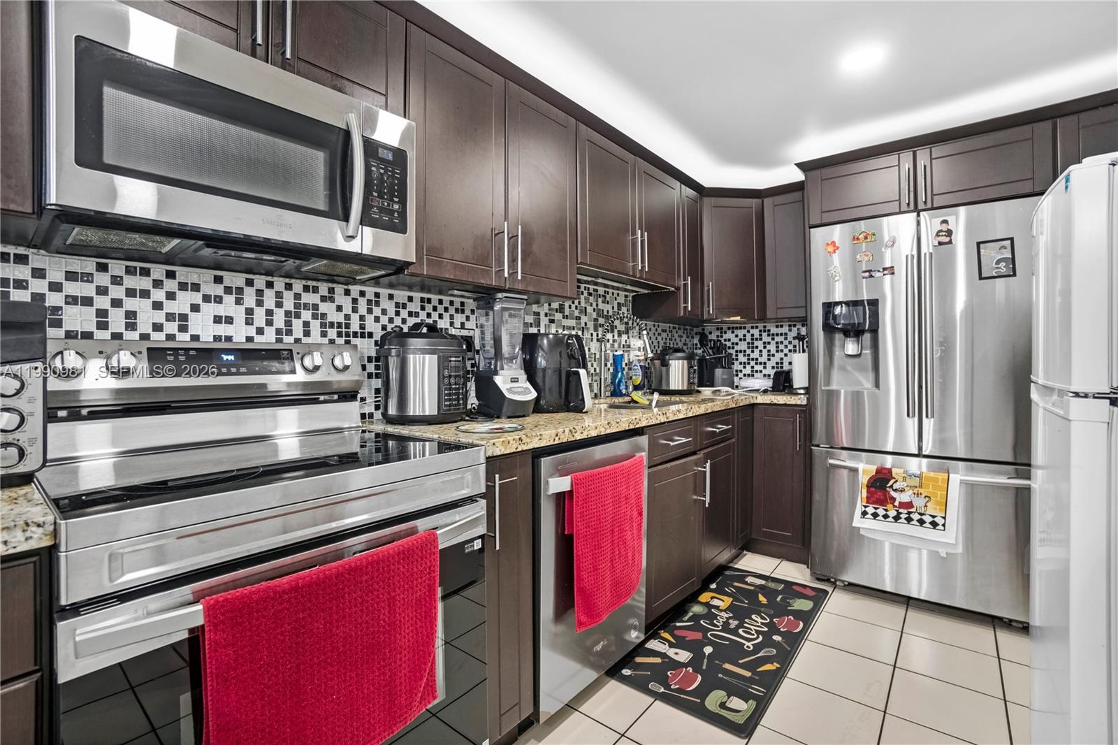 9403 Southwest 76th Street, Unit Y17 Miami, FL 33173 - Photo 1 of 30 a kitchen with stainless steel appliances a sink stove and refrigerator