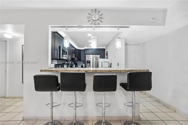 a kitchen with stainless steel appliances a sink cabinets and a counter top space