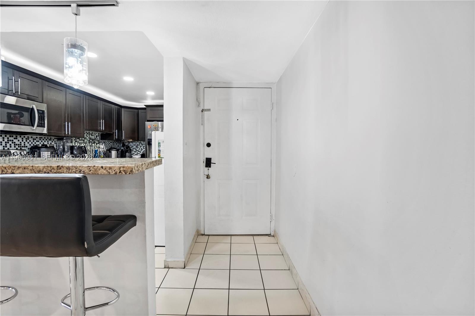 9403 Southwest 76th Street, Unit Y17 Miami, FL 33173 - Photo 14 of 30 a kitchen with stainless steel appliances a sink cabinets and a counter top space