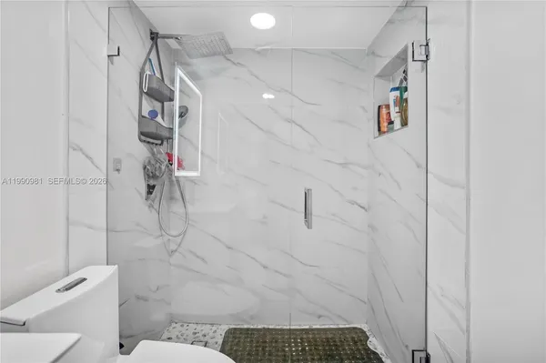 a bathroom with a sink toilet and shower