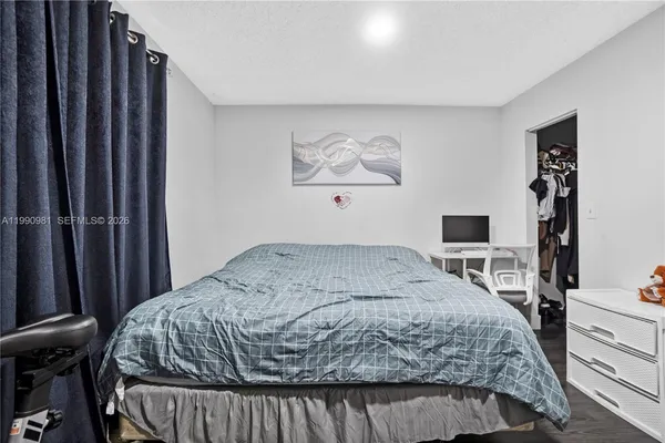 a bedroom with a bed and a dresser