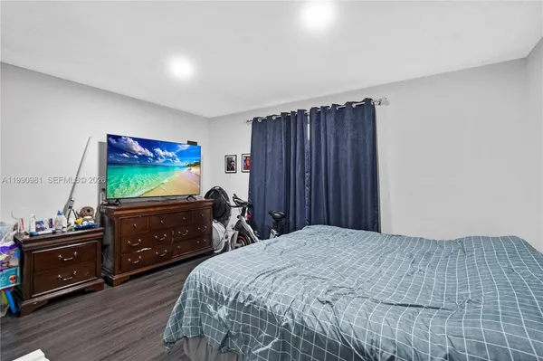 a bedroom with a bed and a dresser