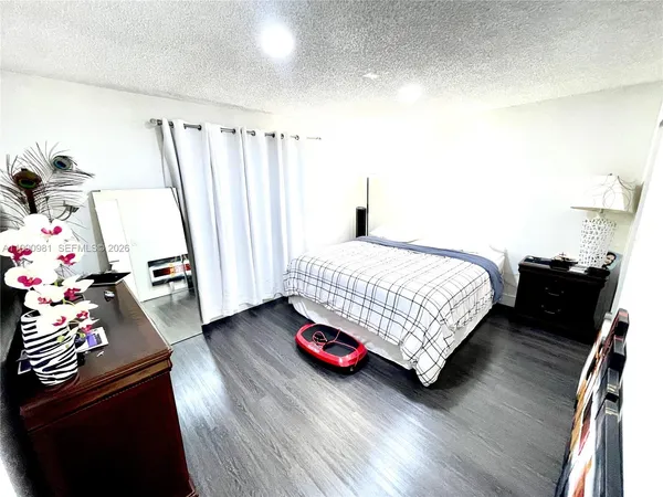 a bathroom with a granite countertop double vanity sink and a mirror