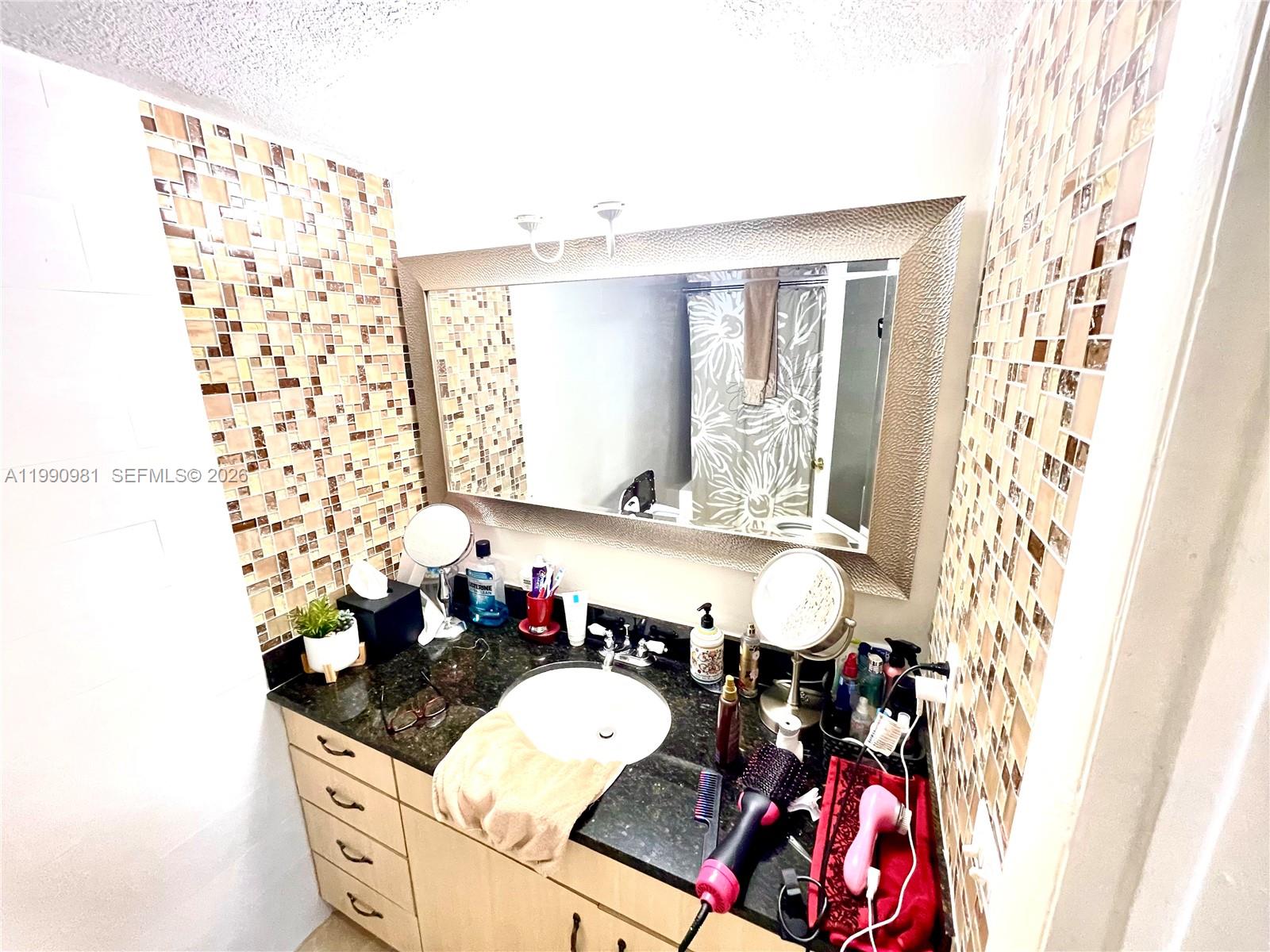 9403 Southwest 76th Street, Unit Y17 Miami, FL 33173 - Photo 22 of 30 a living room with granite countertop furniture and a potted plant