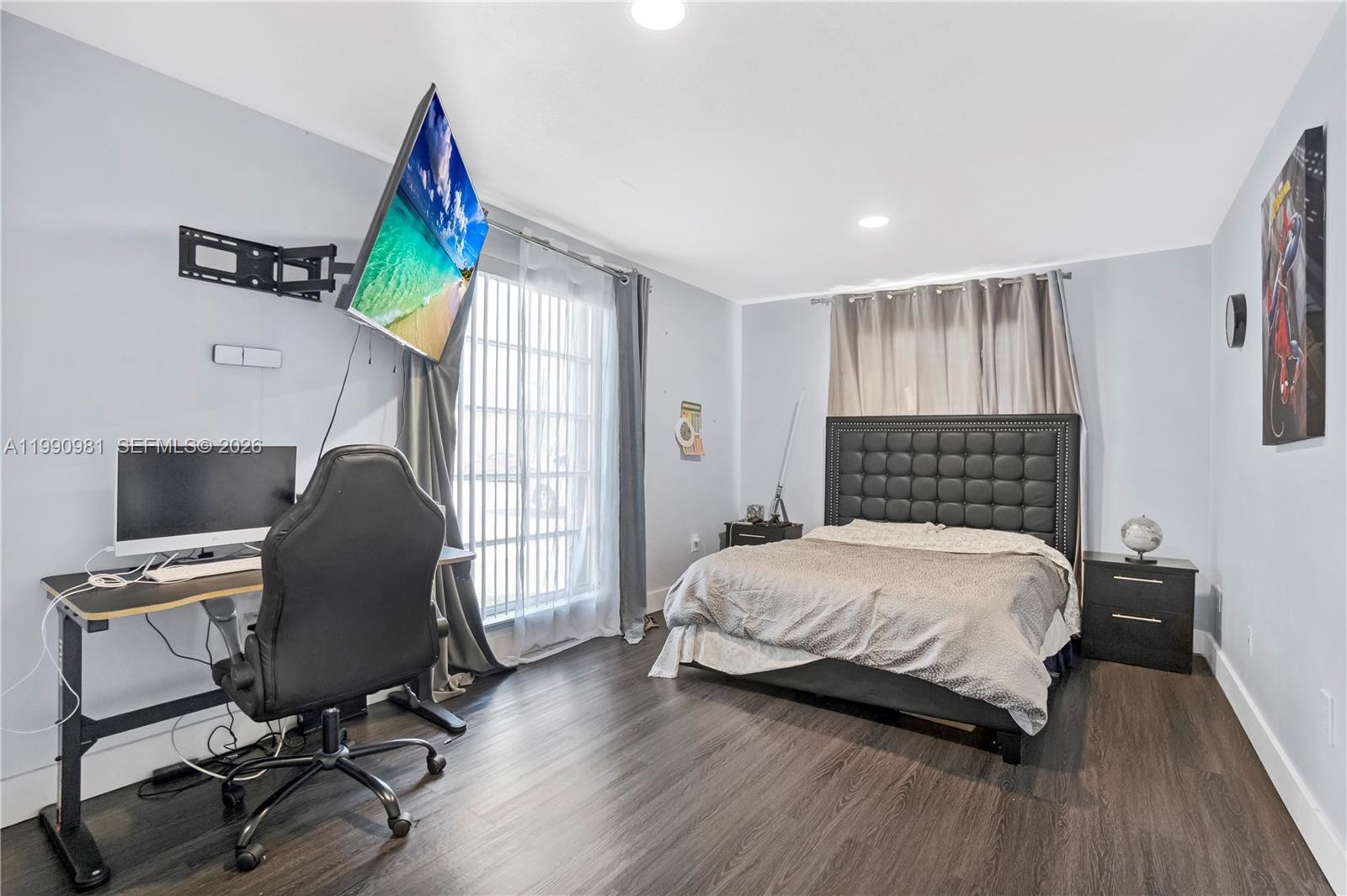 9403 Southwest 76th Street, Unit Y17 Miami, FL 33173 - Photo 24 of 30 a bedroom with a bed and a chair
