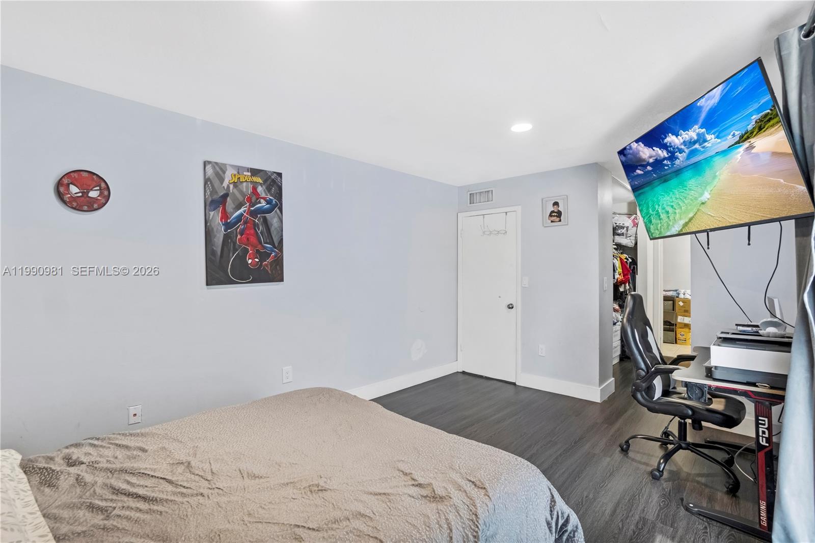9403 Southwest 76th Street, Unit Y17 Miami, FL 33173 - Photo 26 of 30 a bedroom with a bed and a flat screen tv
