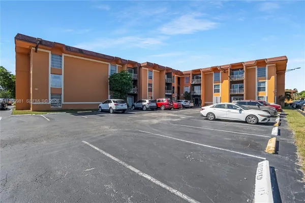 a couple of cars parked in front of a building