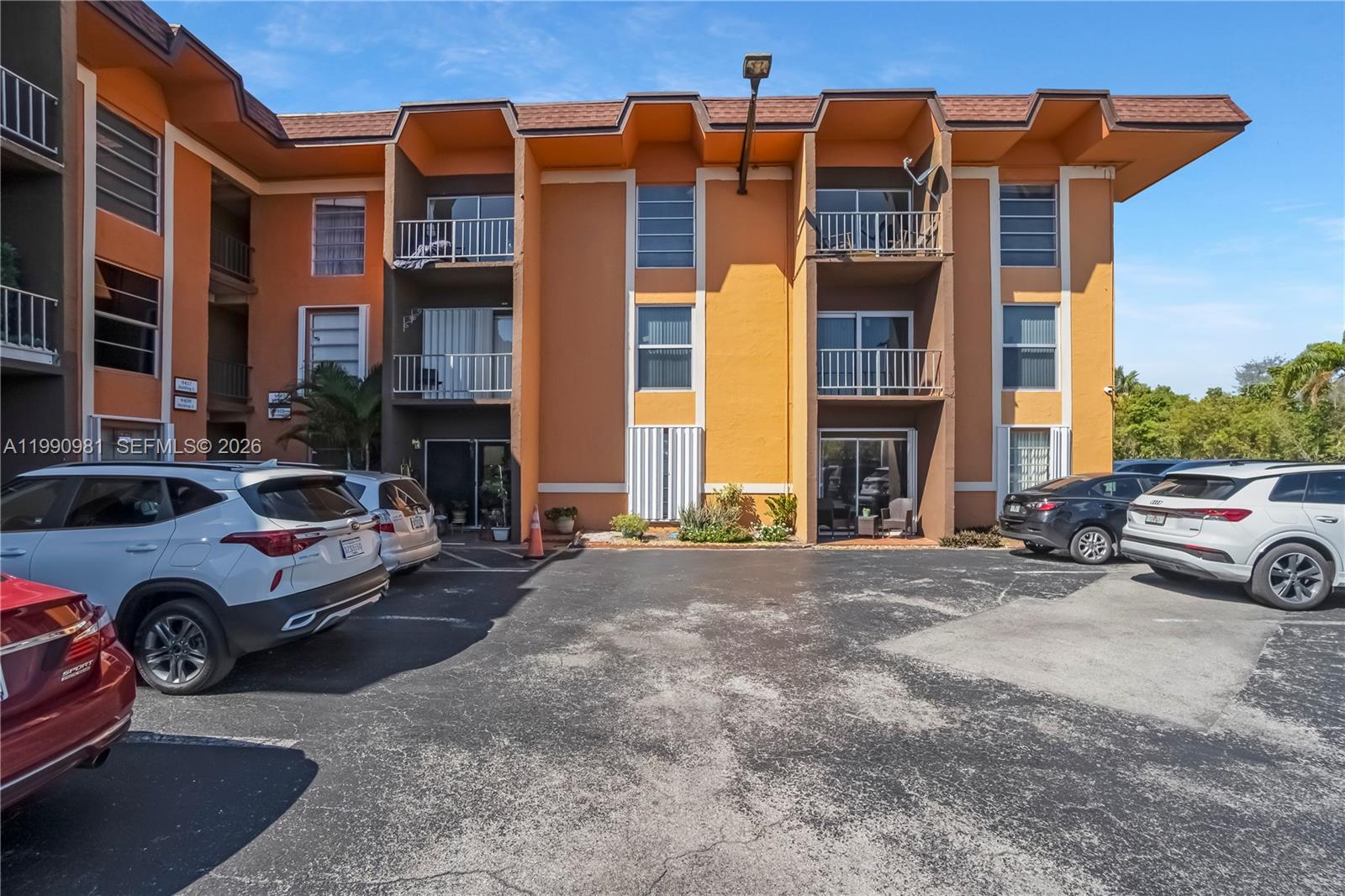 9403 Southwest 76th Street, Unit Y17 Miami, FL 33173 - Photo 28 of 30 a couple of cars parked in front of a building