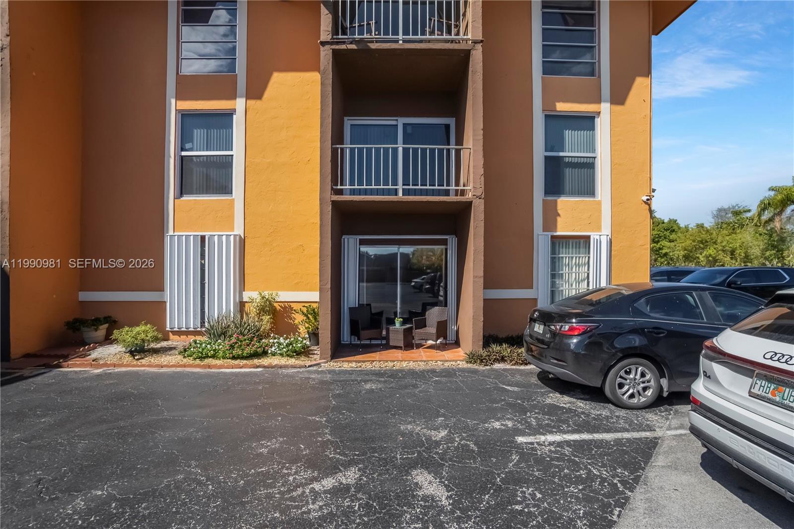 9403 Southwest 76th Street, Unit Y17 Miami, FL 33173 - Photo 29 of 30 a view of a car parked in front of a building