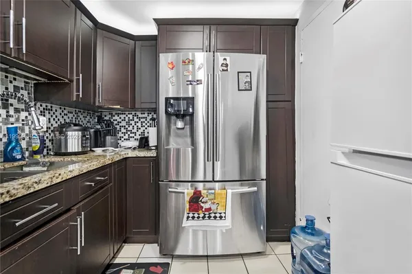 a kitchen with a refrigerator and a sink