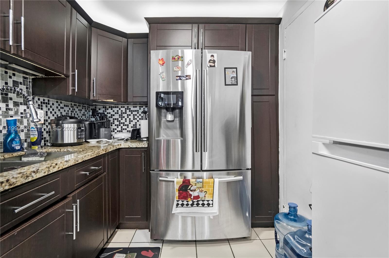 9403 Southwest 76th Street, Unit Y17 Miami, FL 33173 - Photo 4 of 30 a kitchen with a refrigerator and a sink