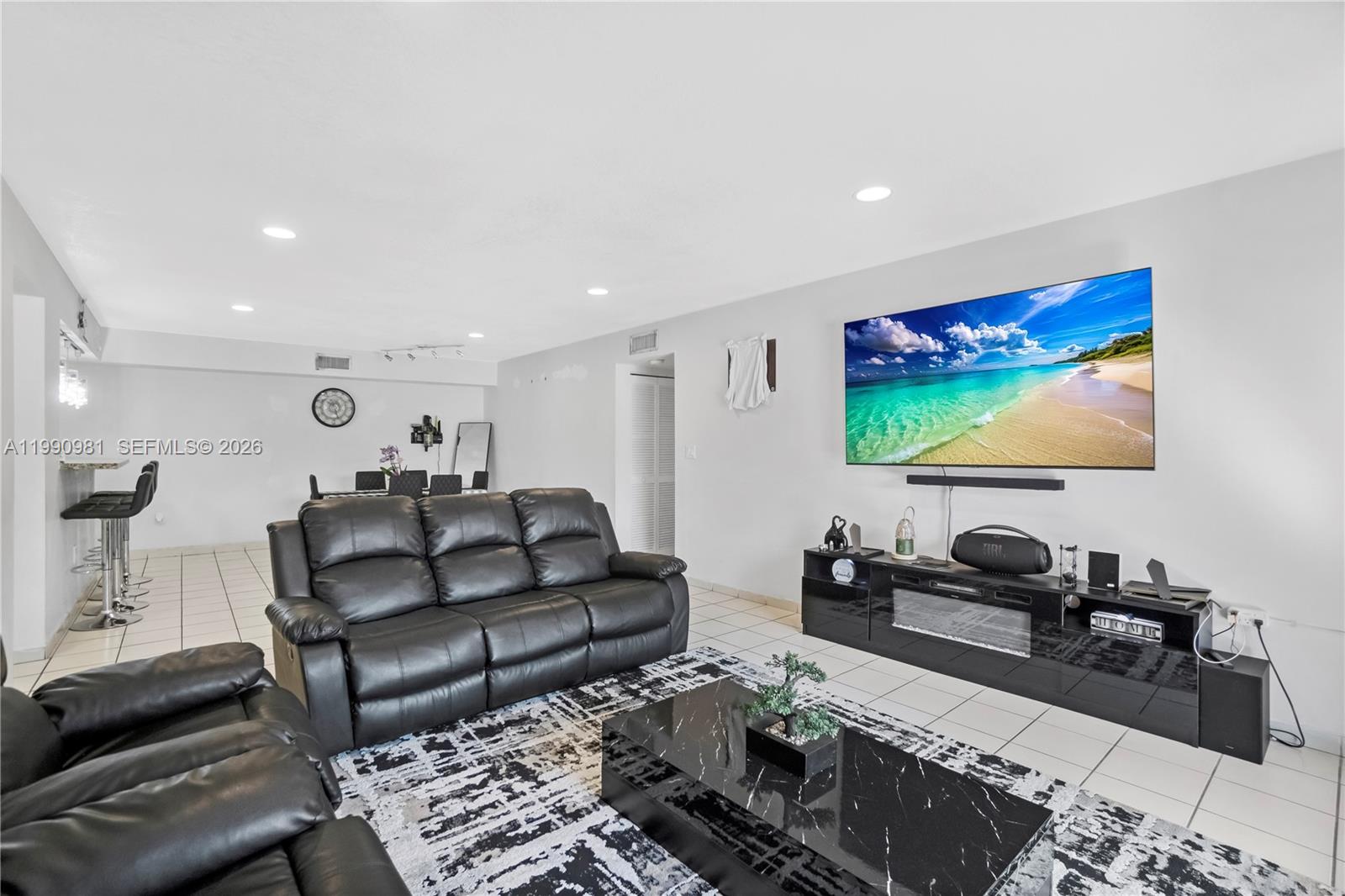 9403 Southwest 76th Street, Unit Y17 Miami, FL 33173 - Photo 5 of 30 a living room with furniture and a flat screen tv