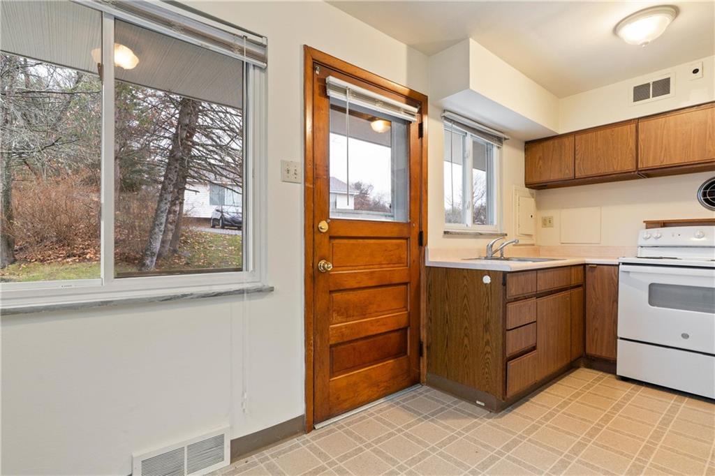 718 West Ingomar Road, Unit 2 Pittsburgh, PA 15237 - Photo 5 of 10 a kitchen with a stove a sink and a window