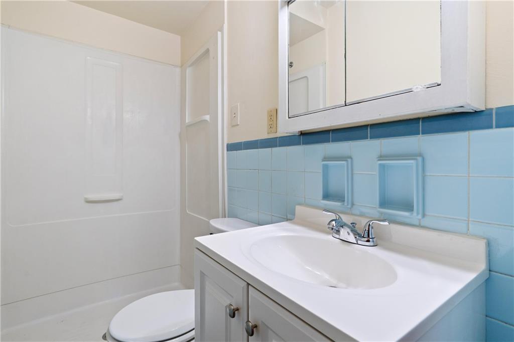 718 West Ingomar Road, Unit 2 Pittsburgh, PA 15237 - Photo 9 of 10 a bathroom with a sink toilet and vanity