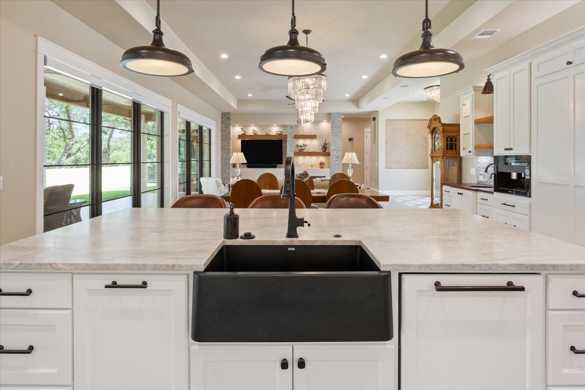 309 Highland Spring Lane Georgetown, TX 78633 - Photo 12 of 40 All Plumbing Fixtures are Koehler oil rubbed bronze. The Blanco brand farm sink is from the Silgranit Sink Collection. Fully integrated Miele Dishwasher with Custom Panel is just to the right of the sink...