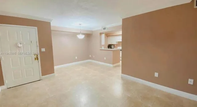 an empty room with windows and entrance