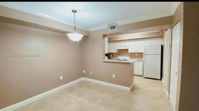 a kitchen with a sink a refrigerator and a stove