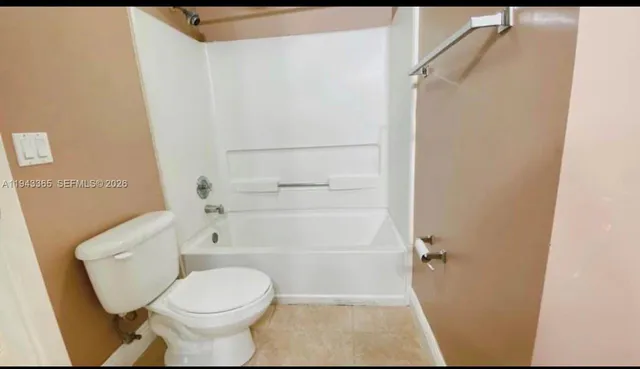 an empty room with an entrance to other room