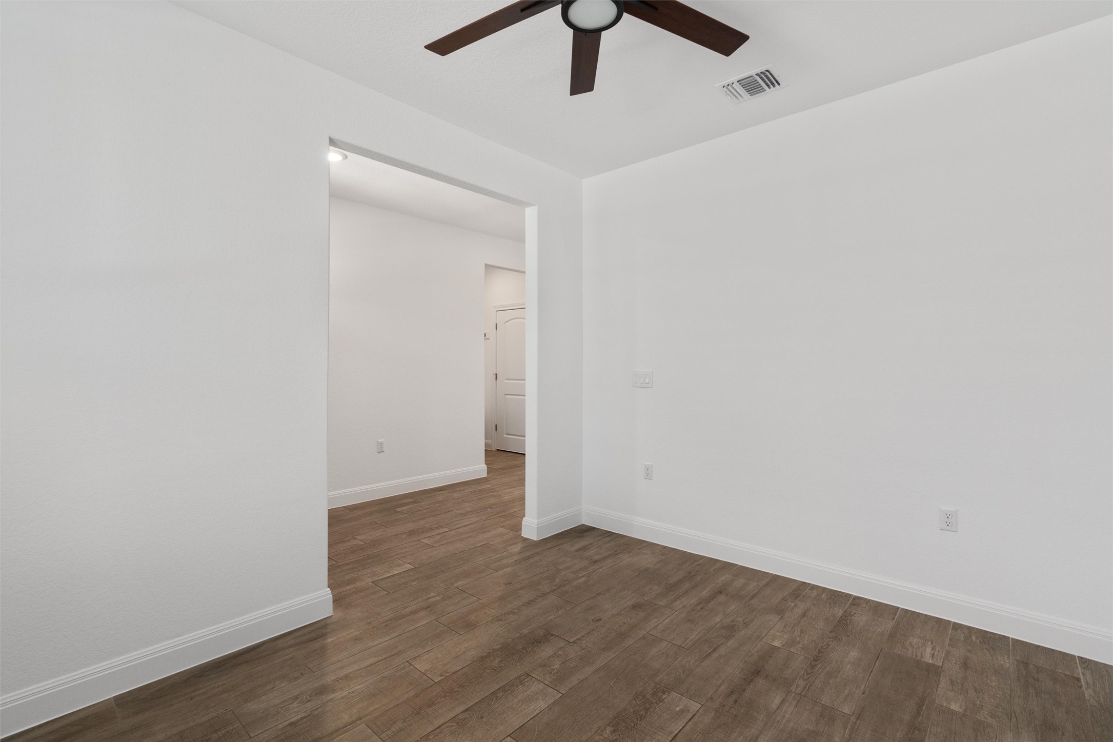 202 Spanish Star Street Georgetown, TX 78633 - Photo 6 of 32 an empty room with wooden floor ceiling fan and window