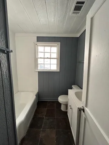 a bathroom with a bathtub and toilet