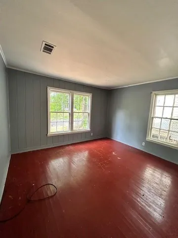 an empty room with windows and closet