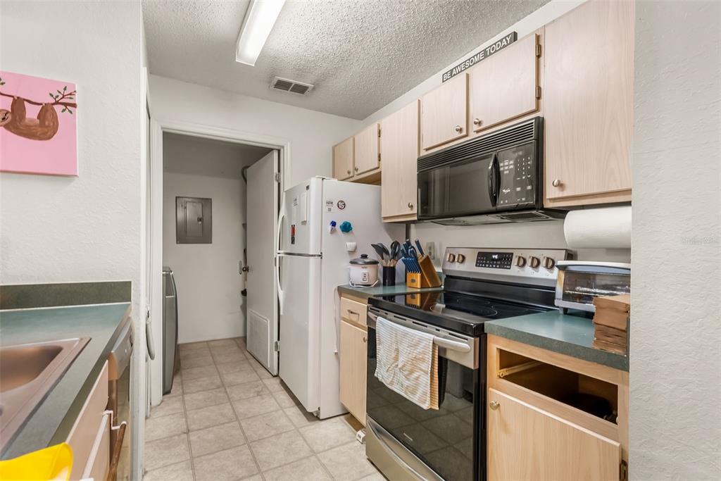 3705 Southwest 27th Street, Unit 615 Gainesville, FL 32608 - Photo 11 of 27 a kitchen with cabinets and steel stainless steel appliances