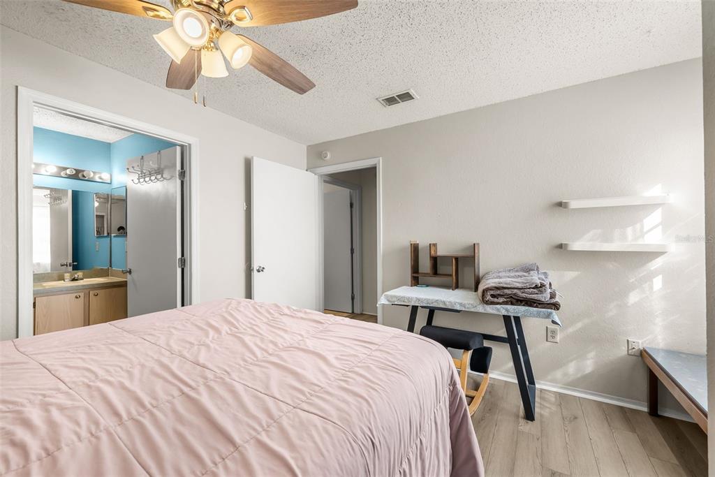 3705 Southwest 27th Street, Unit 615 Gainesville, FL 32608 - Photo 13 of 27 a bedroom with a bed and a chandelier