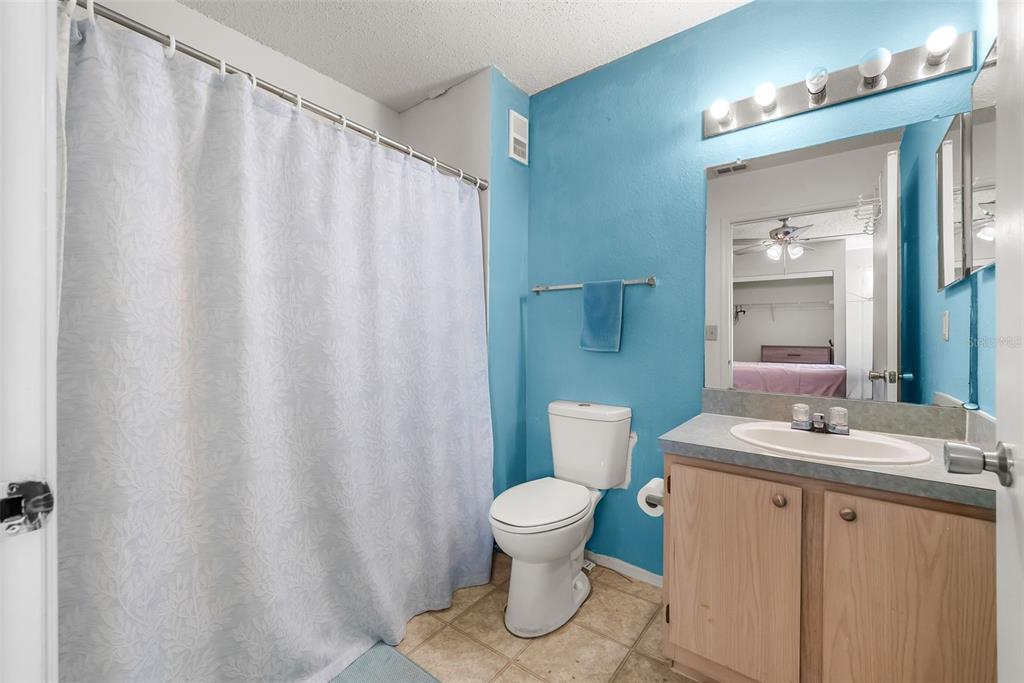 3705 Southwest 27th Street, Unit 615 Gainesville, FL 32608 - Photo 14 of 27 a bathroom with a sink a toilet and a mirror