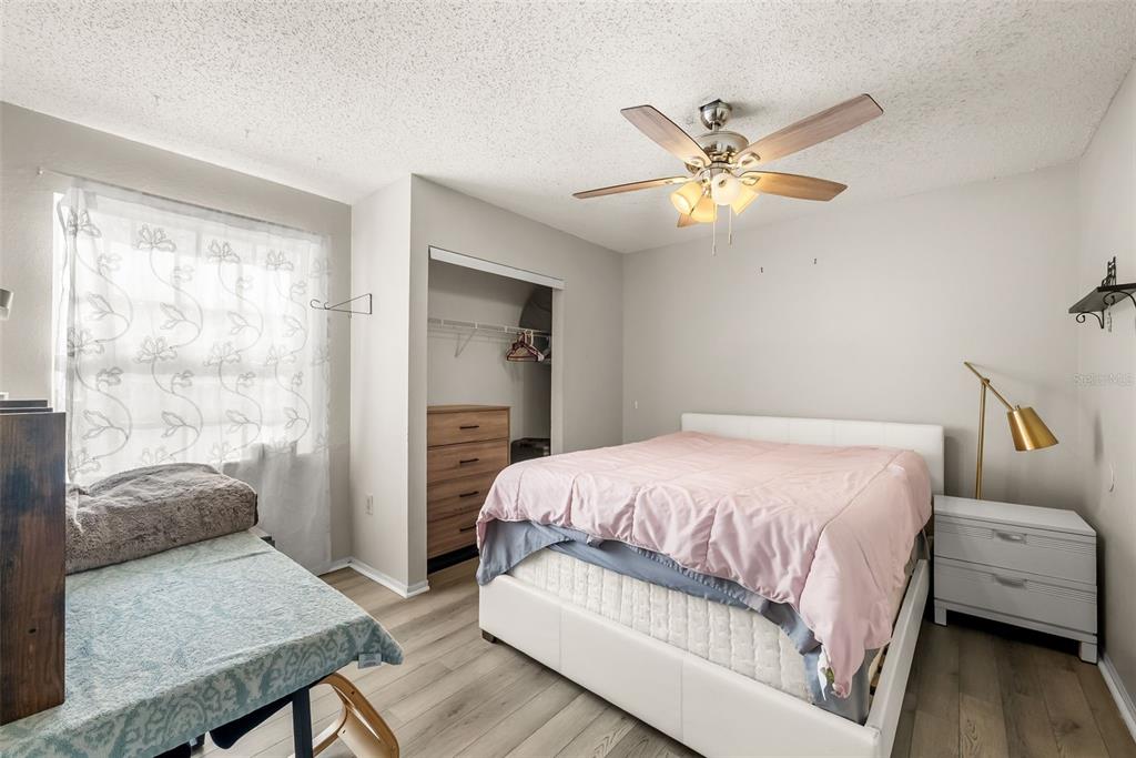 3705 Southwest 27th Street, Unit 615 Gainesville, FL 32608 - Photo 15 of 27 a bedroom with a bed and a chandelier