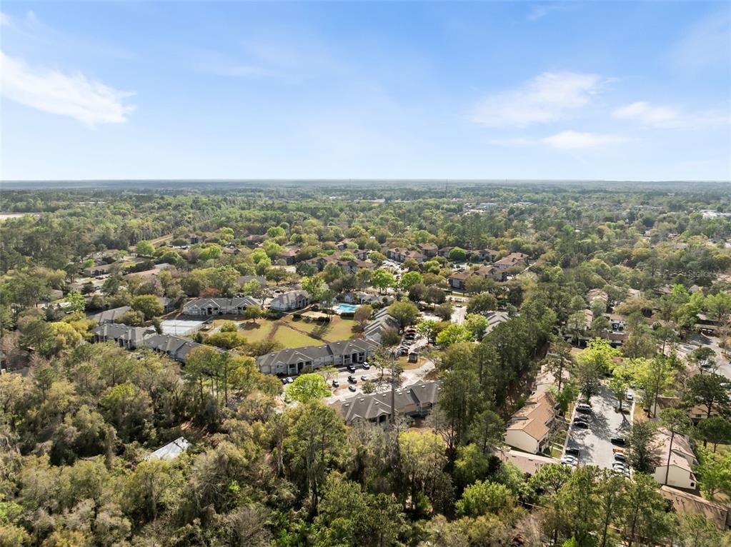 3705 Southwest 27th Street, Unit 615 Gainesville, FL 32608 - Photo 23 of 27 an aerial view of residential houses with outdoor space and trees