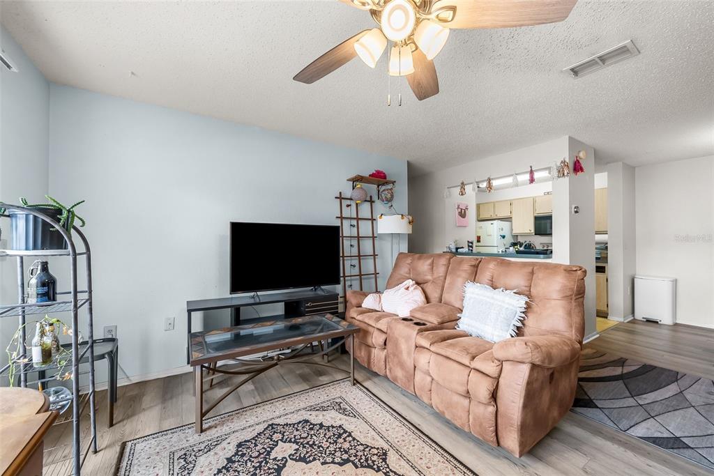 3705 Southwest 27th Street, Unit 615 Gainesville, FL 32608 - Photo 6 of 27 a living room with furniture and a flat screen tv