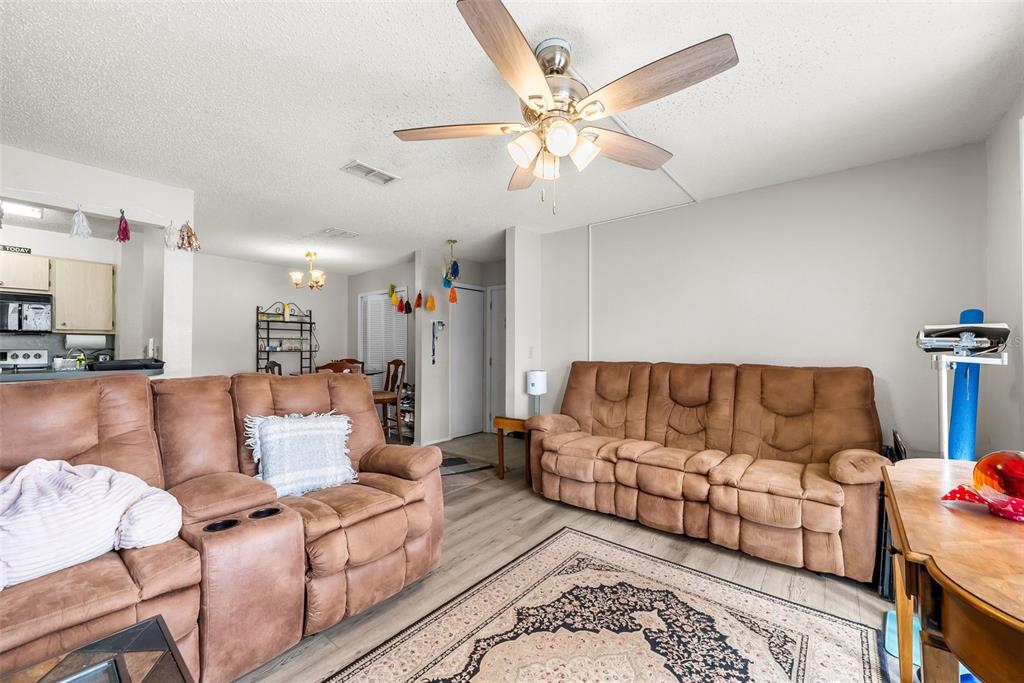 3705 Southwest 27th Street, Unit 615 Gainesville, FL 32608 - Photo 7 of 27 a living room with furniture and a chandelier