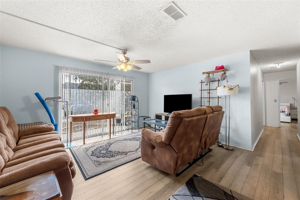 3705 Southwest 27th Street, Unit 615 Gainesville, FL 32608 - Photo 8 of 27 a living room with furniture and a flat screen tv