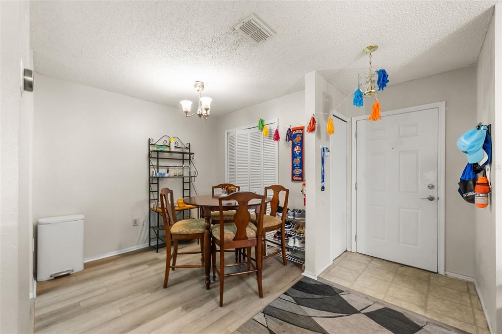 3705 Southwest 27th Street, Unit 615 Gainesville, FL 32608 - Photo 9 of 27 a view of a dining room with furniture and wooden floor